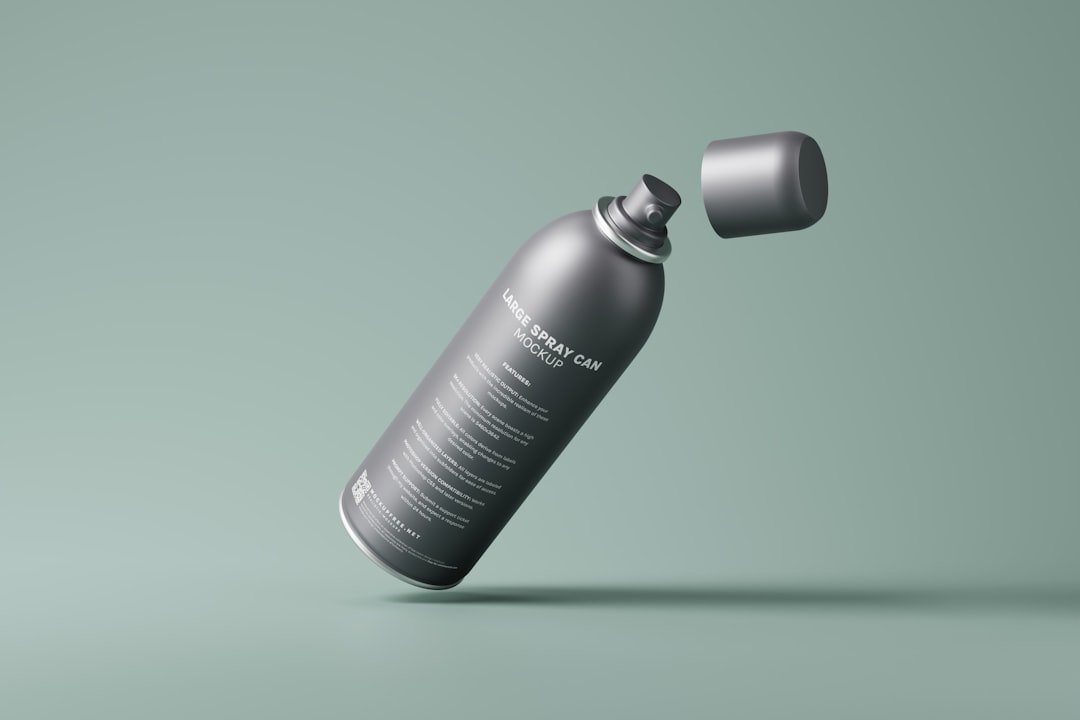 A cosmetic spray can mockup set featuring a large size spray can with a small cap and curved body. Download free PSD mockups from https://mockupfree.net